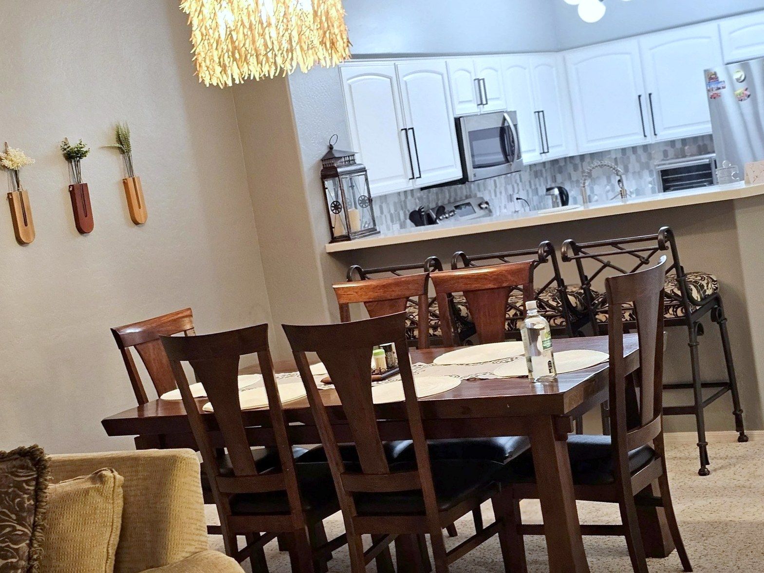 Dining room opening into a white kitchen, cleaned