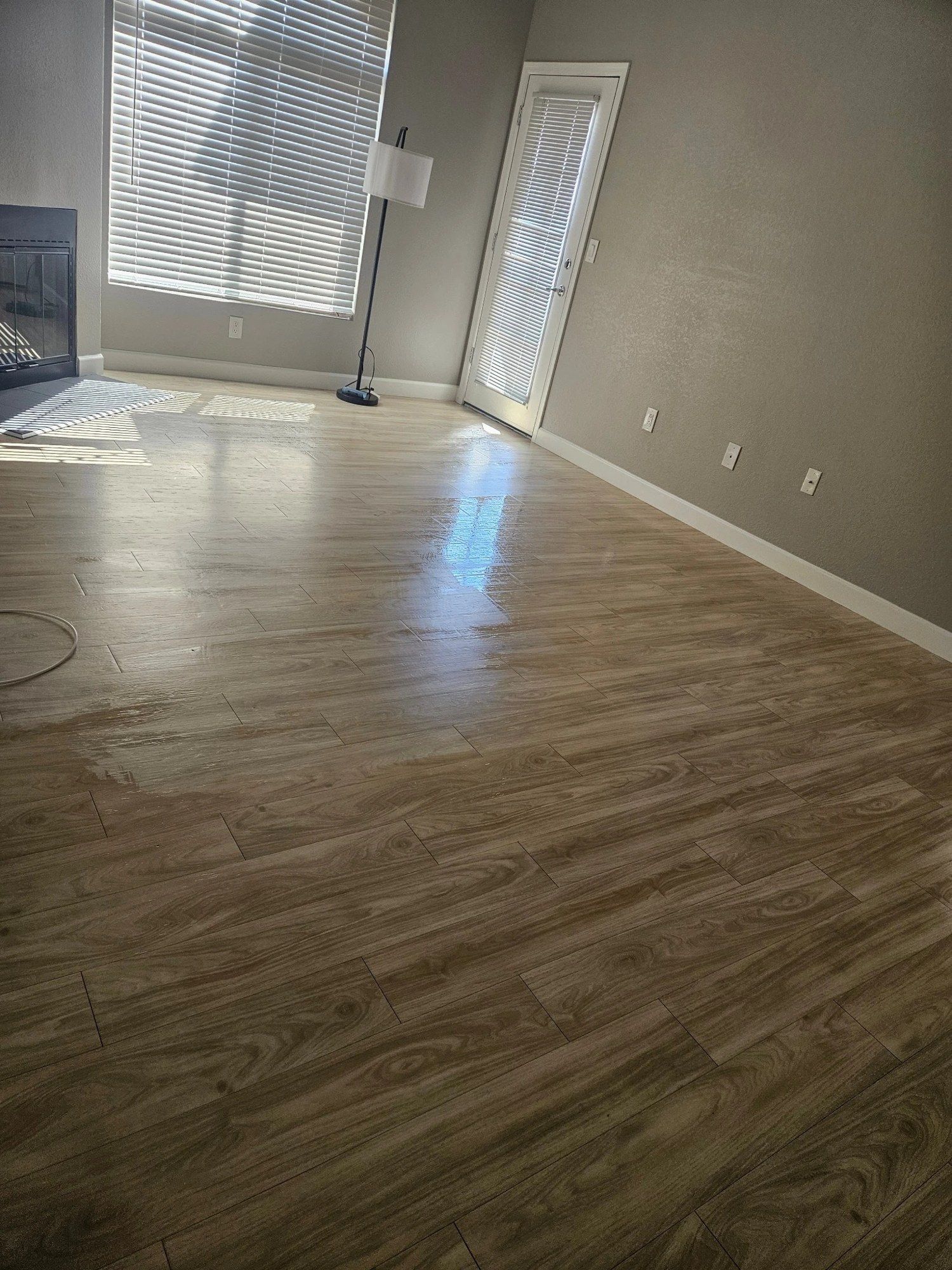 Empty living room with laminate floors after a move-out clean