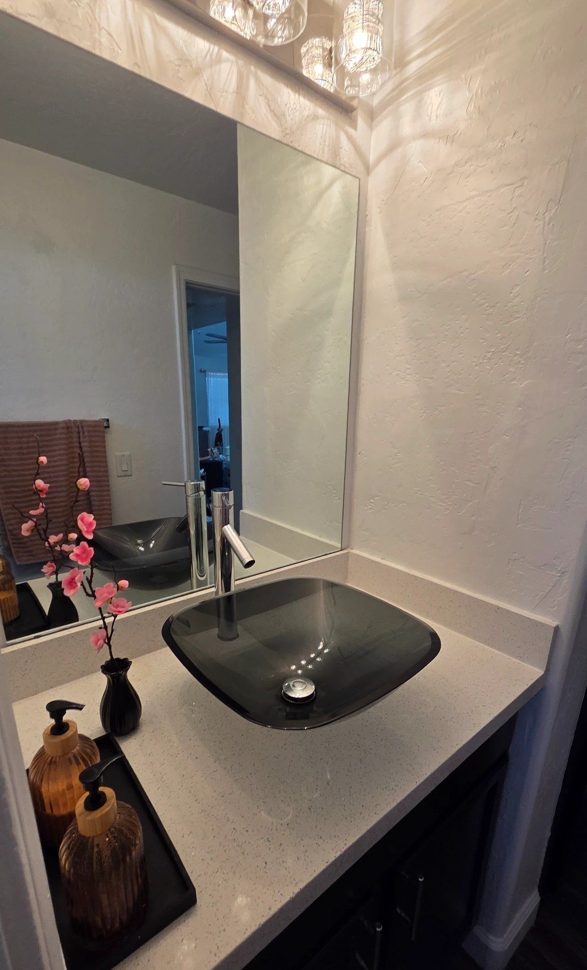Bathroom vanity with a glass vessel sink, cleaned